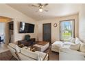 Bright living room featuring stylish furniture, a ceiling fan, and a view of the outdoors at 2341 Sheila Ln, North Port, FL 34286