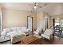 Cozy living room with a sofa, chairs, hardwood floors, and access to a dining area at 2341 Sheila Ln, North Port, FL 34286