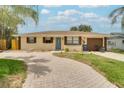 Inviting single-story home with a brick-paved driveway, well-kept lawn, and a tidy front garden at 2715 36Th Avenue E Ter, Bradenton, FL 34208