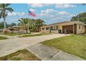 Street view of a cozy home featuring lush landscaping, a rock feature, and a well-maintained lawn at 2715 36Th Avenue E Ter, Bradenton, FL 34208