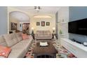 Cozy living room with a modern sofa, stylish decor, and an archway leading to the dining area at 2715 36Th Avenue E Ter, Bradenton, FL 34208
