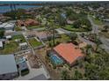 Aerial view of a home with a screened pool and backyard in a residential neighborhood at 321 Sorrento Dr, Osprey, FL 34229