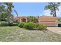 Charming single-story home with a well-manicured lawn and mature palm trees at 321 Sorrento Dr, Osprey, FL 34229