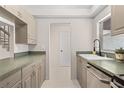 Functional kitchen with neutral cabinets, green countertop, undermount sink, and stainless steel appliances offers a clean aesthetic at 3212 Ramblewood N Dr # 3212, Sarasota, FL 34237