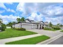 Charming single-story home with brick-paved driveway, well-manicured landscaping, and a three-car garage at 3707 Wild Blossom Pl, Parrish, FL 34219