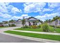 Charming single-story home with brick-paved driveway, well-manicured landscaping, and a three-car garage at 3707 Wild Blossom Pl, Parrish, FL 34219
