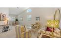 Bright living room features tall ceilings, large windows, and stylish, coordinated furniture at 4208 Balmoral Way, Sarasota, FL 34238