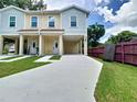 Duplex with covered parking, meticulously maintained lawn, and easy access to both units at 4209 W Woodlawn Ave, Tampa, FL 33614