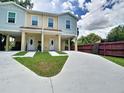 Two-story duplex featuring covered parking, well-maintained lawn, and easy access to both units at 4209 W Woodlawn Ave, Tampa, FL 33614