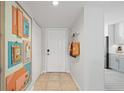 Welcoming entryway features a white front door, tiled floor, and colorful decor at 4410 Fairways Blvd # 104, Bradenton, FL 34209