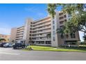 Condo building exterior with balconies, landscaping, parking and prominent signage is featured at 4410 Fairways Blvd # 104, Bradenton, FL 34209