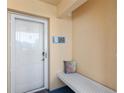 Condo front door featuring unit number, bench and pillow at 4410 Fairways Blvd # 104, Bradenton, FL 34209