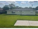 Expansive backyard featuring lush green grass and a concrete patio, perfect for outdoor entertaining at 48 Dade Ave, Sarasota, FL 34232