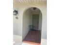 Charming entryway with arched doorway, brick floor, and a cozy seating area, number 48 at 48 Dade Ave, Sarasota, FL 34232