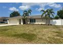 Charming single-story home featuring a well-maintained lawn, palm trees, and a two-car garage at 48 Dade Ave, Sarasota, FL 34232