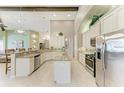 Bright kitchen with granite countertops, stainless steel appliances, and ample cabinet space at 518 Chantilly Trl, Bradenton, FL 34212