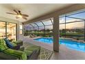 Inviting screened lanai with comfortable seating overlooking a private pool and tranquil water views at 518 Chantilly Trl, Bradenton, FL 34212