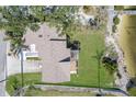 Aerial view of home with lush green lawn, mature trees and driveway at 5912 Riverview Ln, Bradenton, FL 34209