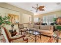 Bright living room with a ceiling fan, plantation shutters, and stylish furniture at 6552 Moorings Point Cir # 201, Lakewood Ranch, FL 34202
