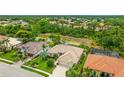 Lovely aerial view of a single-story home with a three-car garage, lush lawn and mature trees at 7126 Southgate Ct, Sarasota, FL 34243