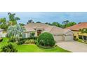 Charming single-story home with a well-manicured lawn and a three-car garage in a lush neighborhood at 7126 Southgate Ct, Sarasota, FL 34243