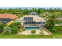 This single-story home features a backyard pool with screened-in patio and solar panels on the roof at 7126 Southgate Ct, Sarasota, FL 34243