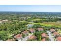 Expansive aerial view of the community showcasing mature landscaping and nearby water feature at 7160 Cedar Hollow Cir, Bradenton, FL 34203