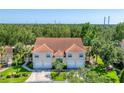 Inviting exterior view of home with tile roof, manicured lawn, and a two-car garage at 7160 Cedar Hollow Cir, Bradenton, FL 34203