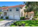 Charming home exterior with lush lawn, a two-car garage, and manicured landscaping at 7160 Cedar Hollow Cir, Bradenton, FL 34203