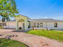 Charming single story home with a brick driveway and light green entryway at 7779 Holiday N Dr, Sarasota, FL 34231