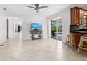 Spacious living room with tile floors and sliding glass doors to the pool at 7779 Holiday N Dr, Sarasota, FL 34231