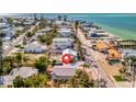 Quaint beach house with tropical landscaping and a serene street in a vibrant coastal neighborhood near the ocean at 880 N Shore Dr, Anna Maria, FL 34216