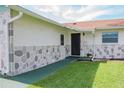 Inviting front entrance with a charming stone accent wall and well-maintained landscaping at 1004 65Th W Ave, Bradenton, FL 34207