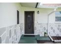 Home's front entrance with a welcoming door and stone accents at 1004 65Th W Ave, Bradenton, FL 34207