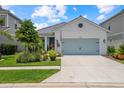 Inviting single-story home featuring a neat front yard, two-car garage, and an attractive facade in a lovely community at 10120 Canaveral Cir, Sarasota, FL 34241