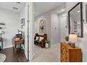 Inviting hallway featuring tile flooring, a decorative mirror, and seamless transitions to adjacent living spaces at 10120 Canaveral Cir, Sarasota, FL 34241