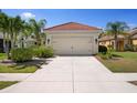 Well-manicured home with concrete driveway and two-car garage provides ample parking at 11435 Fort Lauderdale Pl, Venice, FL 34293