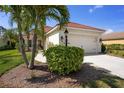 This lovely home features a two-car garage, landscaped yard, and a tile roof at 11435 Fort Lauderdale Pl, Venice, FL 34293