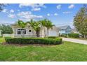 Charming single-story home with a two-car garage, manicured landscaping, and beautiful palm trees at 12642 Cara Cara Loop, Bradenton, FL 34212
