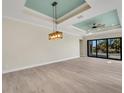 Open-concept living area featuring tile floors, recessed lights, and sliding glass doors to the lanai at 144 Spring Dr, Rotonda West, FL 33947