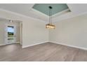 Bright, open living room features recessed lights, tile flooring, and a decorative light fixture at 144 Spring Dr, Rotonda West, FL 33947
