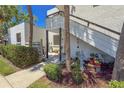 Exterior view of a two-story condo showcasing well-maintained landscaping and walkway at 157 Pinehurst Dr # 157, Bradenton, FL 34210
