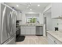 Modern kitchen with stainless steel appliances, granite countertops, and wood-look flooring at 157 Pinehurst Dr # 157, Bradenton, FL 34210