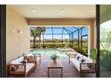 Inviting screened lanai with stylish seating, overlooking the pool and picturesque backyard at 15707 Sacile Ln, Bradenton, FL 34211