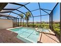 Beautiful pool and spa enclosed within a screened lanai, offering a relaxing outdoor retreat at 15707 Sacile Ln, Bradenton, FL 34211