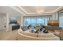 Bright living room features modern decor, ocean views, and a stylish chandelier at 1591 Gulf Of Mexico Dr # 511, Longboat Key, FL 34228