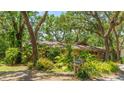 Charming single-story home with lush tropical plants and well-maintained yard at 2061 Misty Sunrise Trl, Sarasota, FL 34240