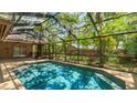 Inviting in-ground screened pool surrounded by a beautiful patio area at 2061 Misty Sunrise Trl, Sarasota, FL 34240