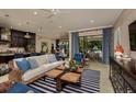 Comfortable living room featuring stylish furniture, a textured wall, and patio access at 21225 Wacissa Dr, Venice, FL 34293