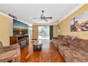 Cozy living room with hardwood floors, plush couches, and a view of the lanai at 230 Fareham Dr, Venice, FL 34293